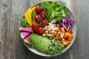 A plate filled with vegetables and other healthy food.