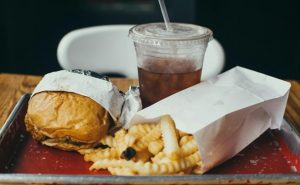 A hamburger, a soda, and fries.