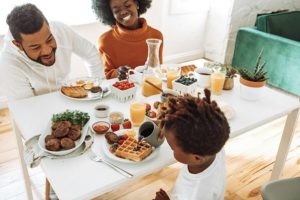 A family enjoying a meal. 