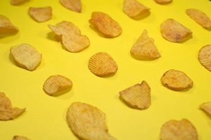 Potato chips on a yellow background. 