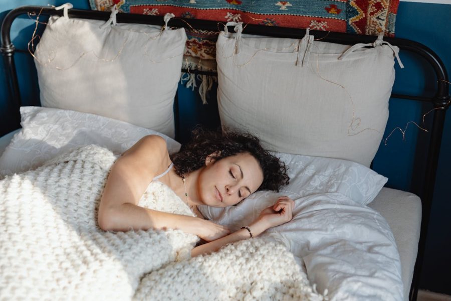 A woman in bed taking advantage of the healing power of sleep