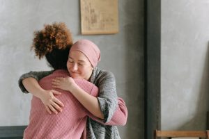 Two women hugging each other.Caption: People appreciate their good deeds being recognized; it creates positive feelings on both sides. 